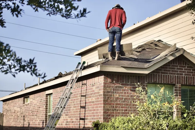 Professional roofer working on a residential roof in Middlesex